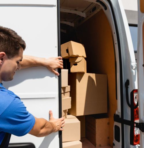 loader-closing-door-of-truck-with-cardboard-boxes-2023-11-27-05-32-06-utc-1024x684 (1)