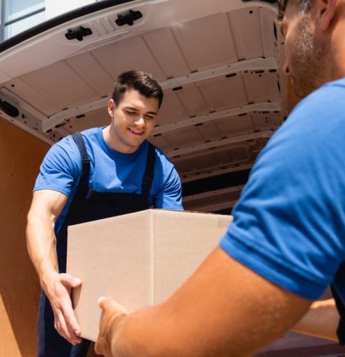 selective-focus-of-loader-holding-cardboard-box-wi-2023-11-27-05-11-16-utc-1024x684